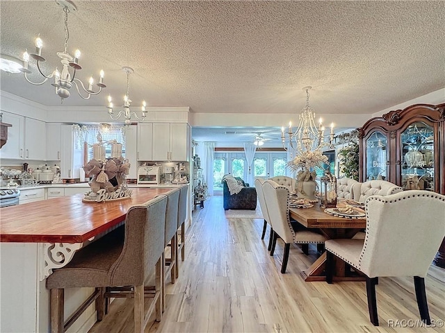 4101 E Gloria Dr, Hernando, FL 34442 - dining space featuring a chandelier, a textured ceiling, and light wood-style floors