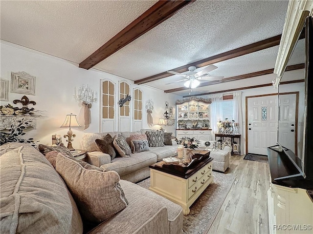 4101 E Gloria Dr, Hernando, FL 34442 - living room with a textured ceiling, light wood finished floors, beamed ceiling, a ceiling fan, and ornamental molding
