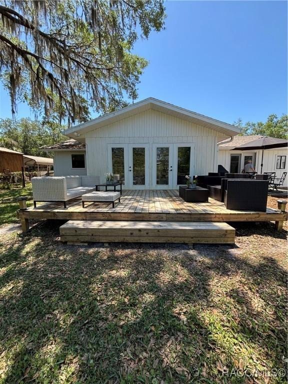 4101 E Gloria Dr, Hernando, FL 34442 - rear view of house with an outdoor hangout area, a wooden deck, and french doors