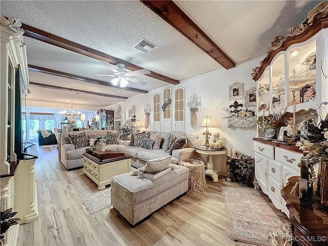 4101 E Gloria Dr, Hernando, FL 34442 - living room with beam ceiling, light wood-style flooring, a textured ceiling, a ceiling fan, and a chandelier