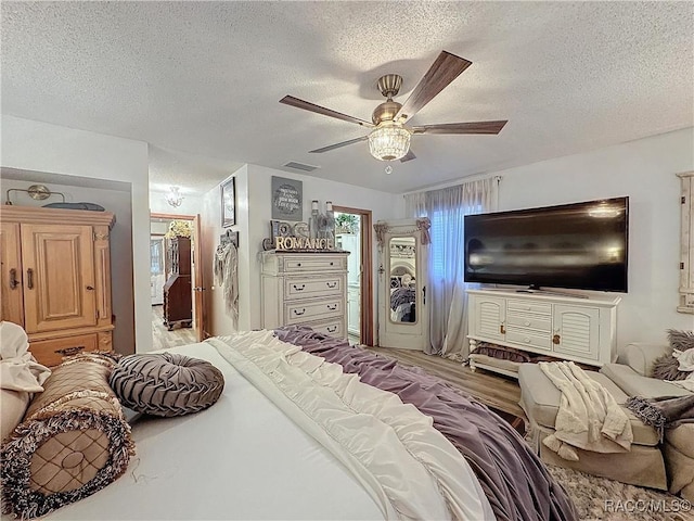 4101 E Gloria Dr, Hernando, FL 34442 - bedroom with a textured ceiling, wood finished floors, and a ceiling fan
