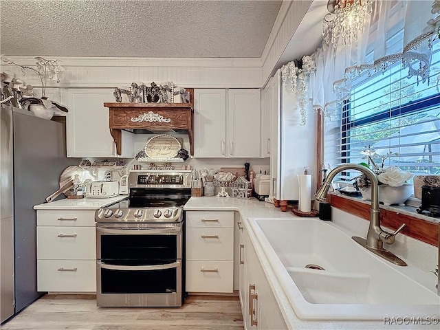 4101 E Gloria Dr, Hernando, FL 34442 - kitchen with appliances with stainless steel finishes, a textured ceiling, light countertops, white cabinetry, and crown molding