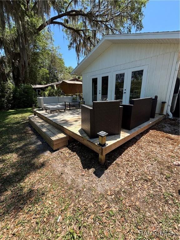4101 E Gloria Dr, Hernando, FL 34442 - wooden deck featuring french doors and an outdoor living space