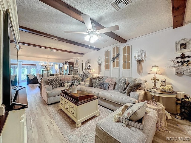 4101 E Gloria Dr, Hernando, FL 34442 - living room with beamed ceiling, a textured ceiling, a chandelier, a ceiling fan, and light wood-style floors