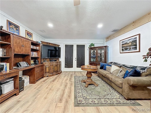 4101 E Gloria Dr, Hernando, FL 34442 - living room with french doors, light wood finished floors, a textured ceiling, a desk, and recessed lighting