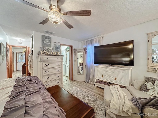 4101 E Gloria Dr, Hernando, FL 34442 - bedroom with a textured ceiling, light wood-type flooring, a ceiling fan, and ensuite bath