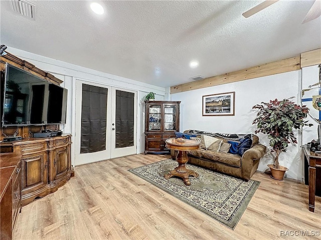 4101 E Gloria Dr, Hernando, FL 34442 - living area with french doors, light wood finished floors, a textured ceiling, ceiling fan, and recessed lighting