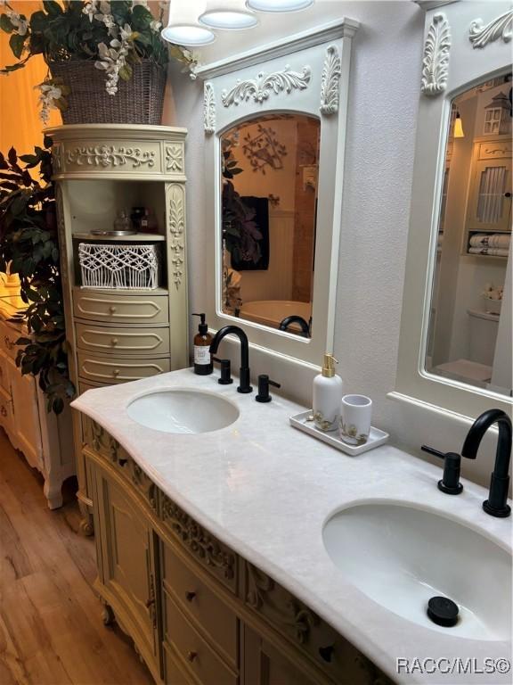 4101 E Gloria Dr, Hernando, FL 34442 - full bathroom featuring wood finished floors and double vanity