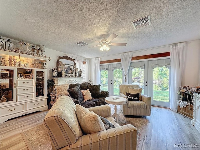 4101 E Gloria Dr, Hernando, FL 34442 - living room featuring french doors, a textured ceiling, ceiling fan, and wood finished floors