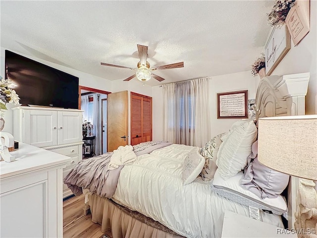 4101 E Gloria Dr, Hernando, FL 34442 - bedroom with a textured ceiling, light wood finished floors, ceiling fan, and a closet
