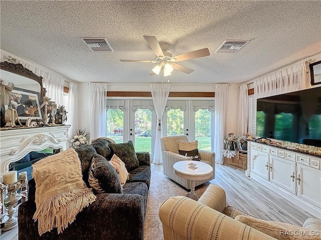 4101 E Gloria Dr, Hernando, FL 34442 - living room featuring french doors, a textured ceiling, a ceiling fan, and light wood finished floors