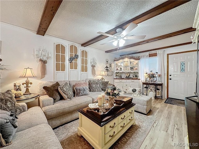 4101 E Gloria Dr, Hernando, FL 34442 - living area with beamed ceiling, a textured ceiling, light wood finished floors, and ceiling fan