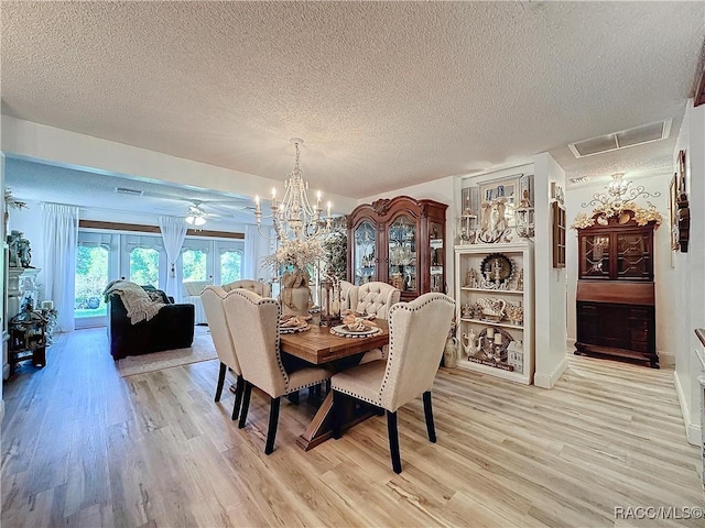 4101 E Gloria Dr, Hernando, FL 34442 - dining room featuring light wood-style floors, a textured ceiling, and a chandelier