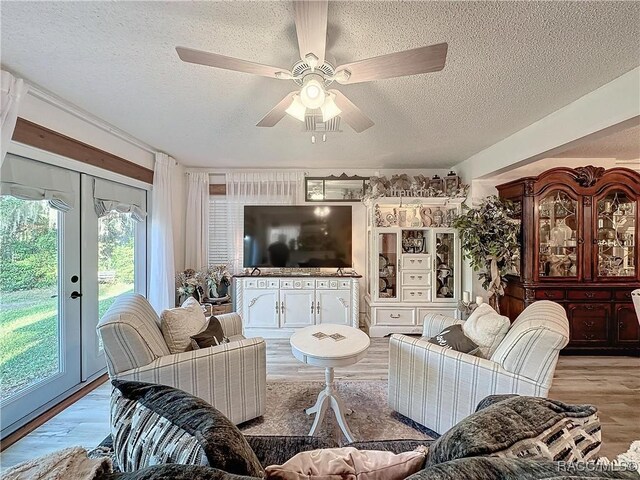 4101 E Gloria Dr, Hernando, FL 34442 - living area featuring a textured ceiling, a ceiling fan, wood finished floors, and french doors