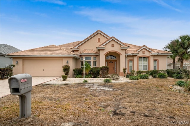 mediterranean / spanish-style home featuring a garage