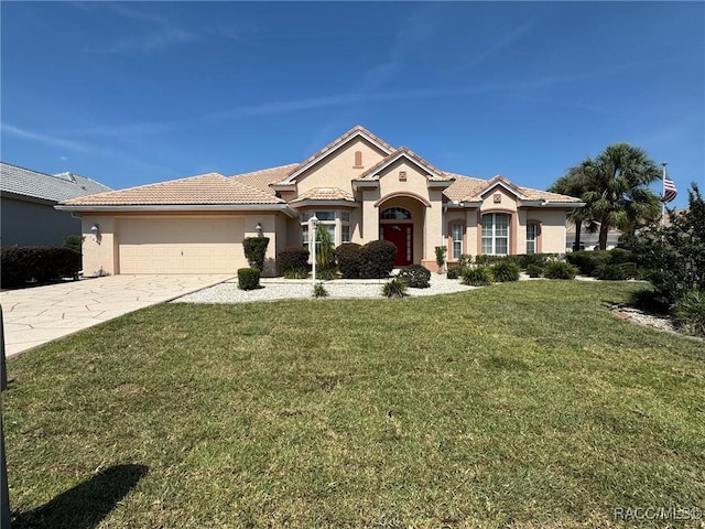 1543 N Killebrew Pt, Hernando, FL 34442 - mediterranean / spanish home featuring stucco siding, a garage, driveway, a front lawn, and a tiled roof