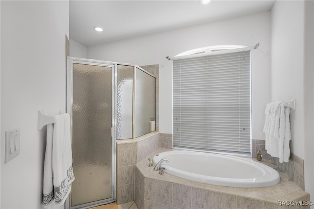 bathroom with separate shower and tub