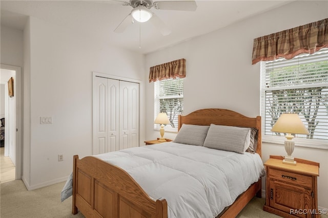 carpeted bedroom featuring ceiling fan and a closet