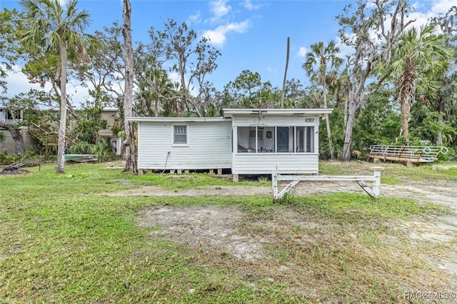 back of property with a sunroom