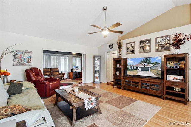 living room featuring vaulted ceiling, hardwood / wood-style floors, and ceiling fan