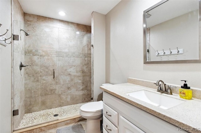 bathroom featuring walk in shower, vanity, and toilet