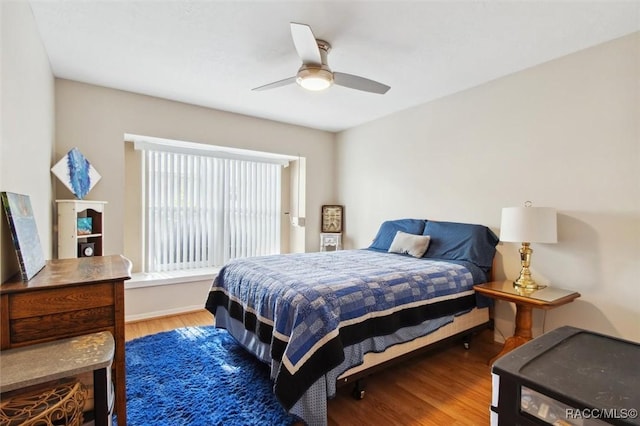 bedroom featuring hardwood / wood-style floors and ceiling fan