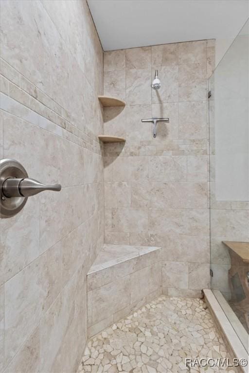 bathroom with tiled shower