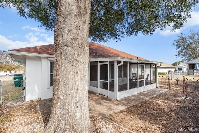 rear view of house with a sunroom