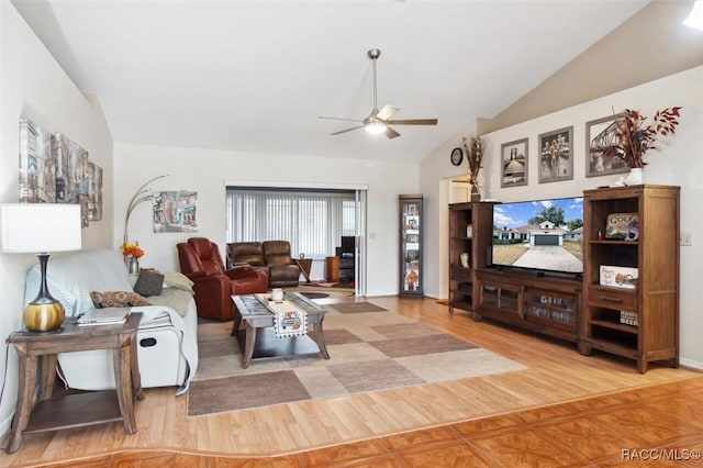 living room with ceiling fan, lofted ceiling, and light wood-type flooring