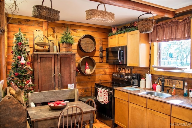 kitchen featuring sink, black electric range, beamed ceiling, wood walls, and decorative light fixtures