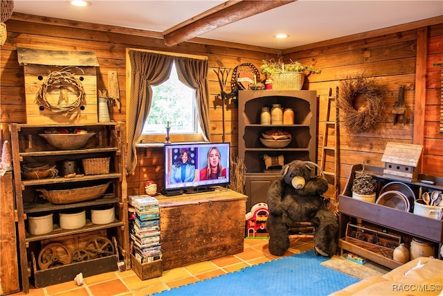 sitting room featuring beamed ceiling and light tile patterned flooring