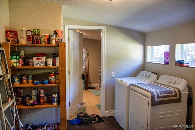 clothes washing area with washer and dryer, wood-type flooring, and a textured ceiling