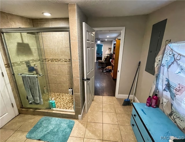 bathroom with tile patterned flooring, electric panel, and an enclosed shower