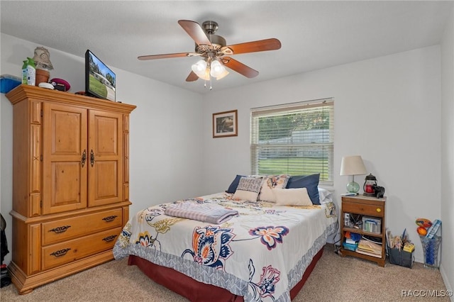 bedroom featuring ceiling fan and light carpet