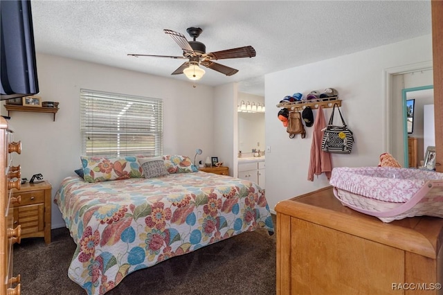 bedroom featuring a ceiling fan, dark carpet, and a textured ceiling