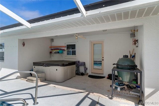 view of patio featuring a lanai and a ceiling fan