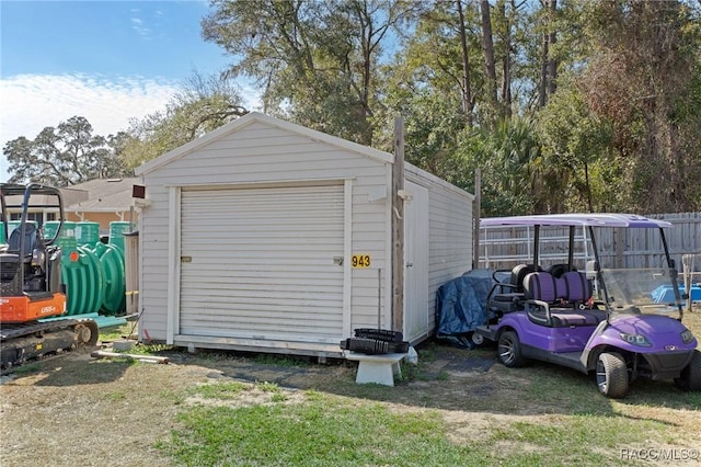 detached garage with driveway and a storage unit