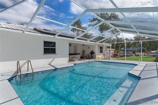 pool featuring a patio area and glass enclosure