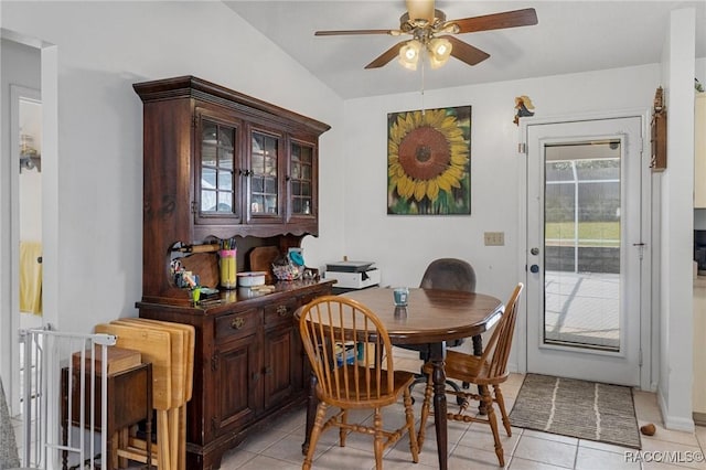 dining area with light tile patterned floors, ceiling fan, and lofted ceiling