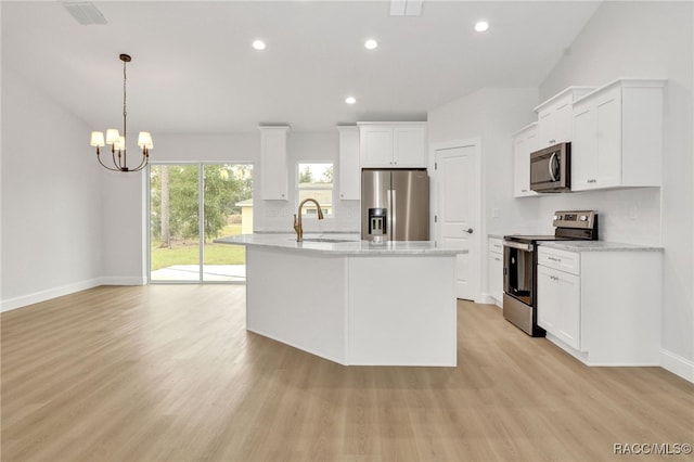 kitchen with white cabinets, stainless steel appliances, and light wood-type flooring