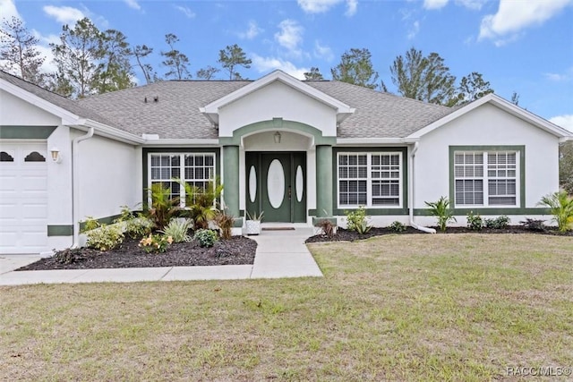 ranch-style house featuring a garage and a front yard