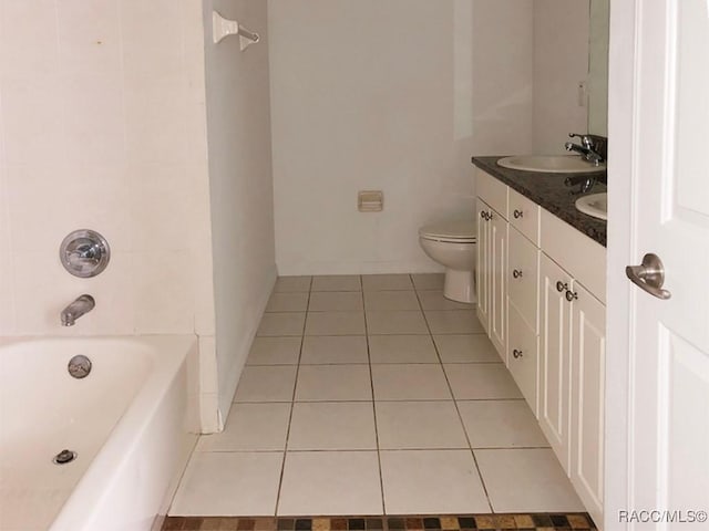 full bathroom featuring washtub / shower combination, tile patterned floors, toilet, and vanity