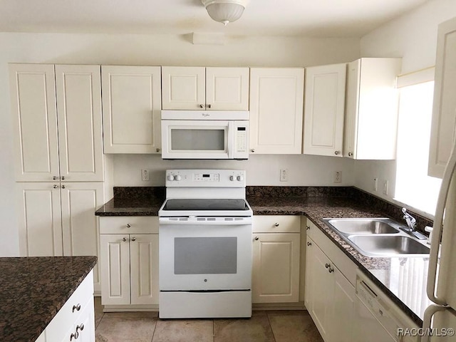 kitchen with white cabinetry, sink, white appliances, and light tile patterned floors