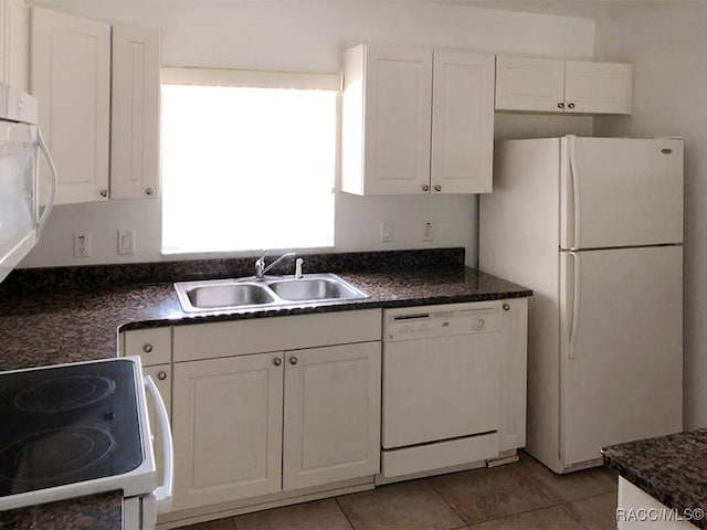 kitchen featuring white cabinetry, sink, white appliances, and light tile patterned flooring