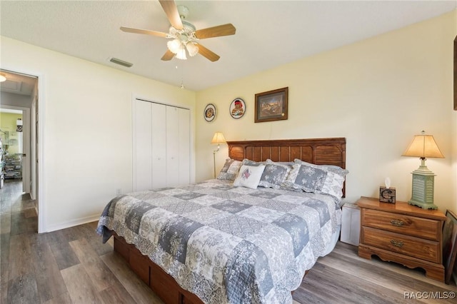 bedroom with a closet, ceiling fan, and dark hardwood / wood-style floors