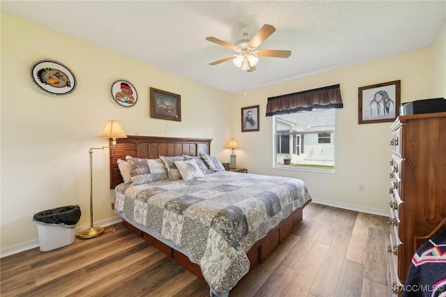 bedroom with dark hardwood / wood-style floors and ceiling fan