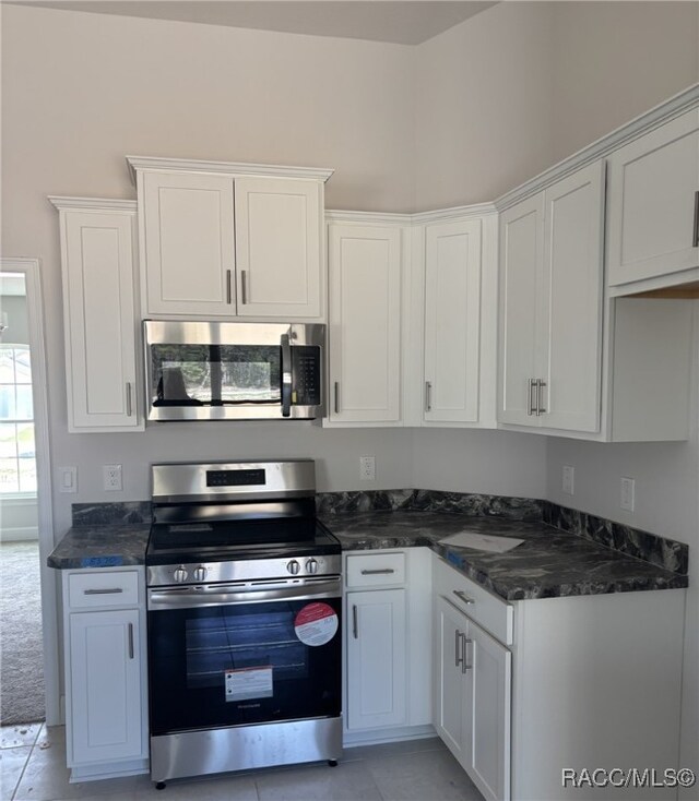 unfurnished bedroom with a tray ceiling and ornamental molding