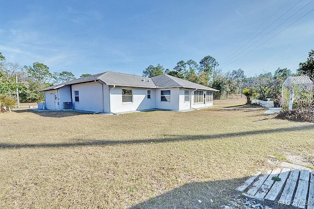 back of house with a lawn