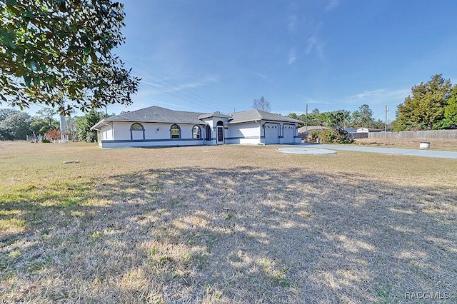 ranch-style home with a garage and a front yard