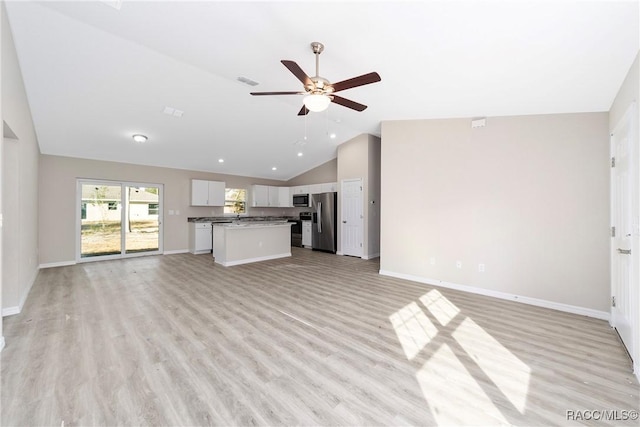 unfurnished living room featuring light hardwood / wood-style floors, ceiling fan, and vaulted ceiling